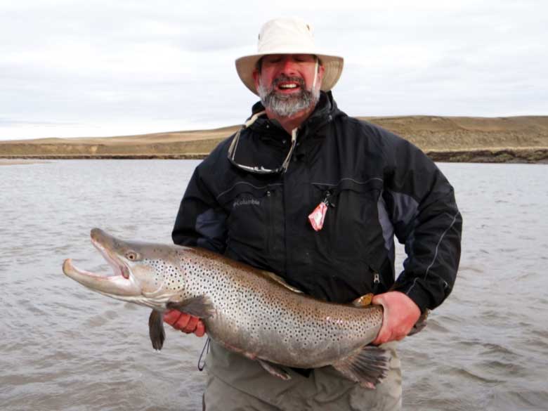 Dr. Keith Barron with a beautiful brown trout in Patagonia.